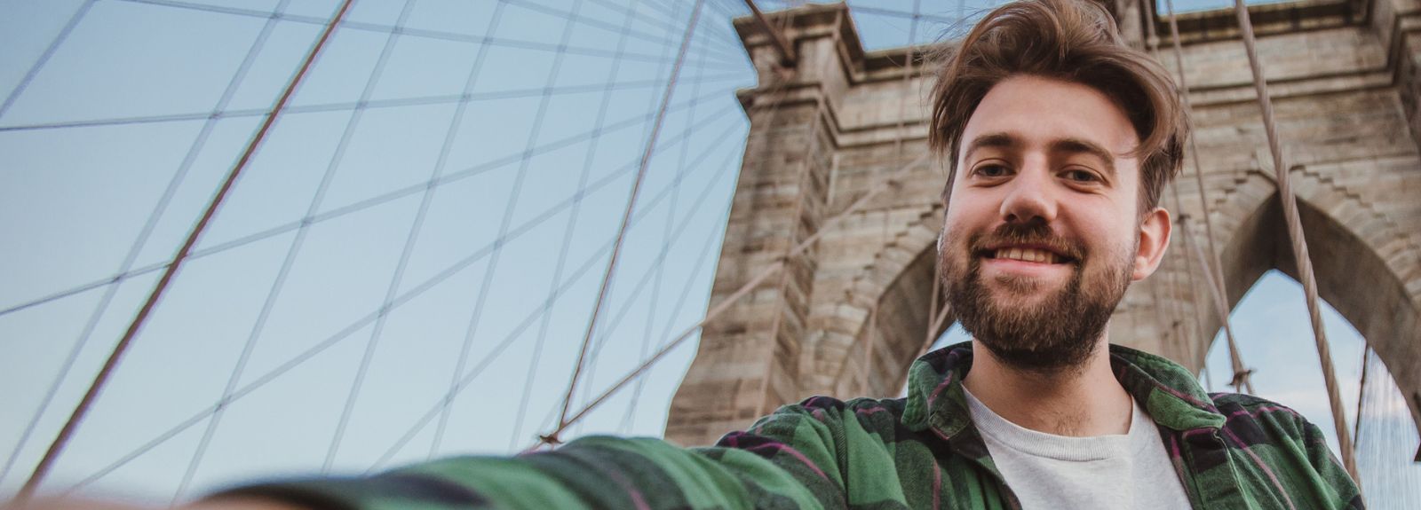 male student taking a selfie at a bridge in the USA
